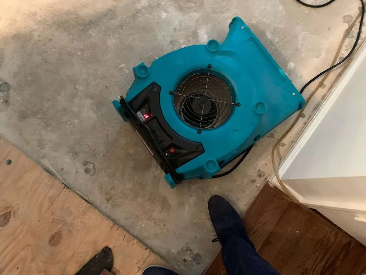 Air mover drying subfloor during Commercial Water Damage Restoration in Manassas